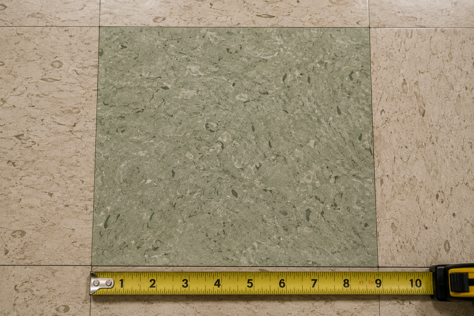 Example of a nine-by-nine style vinyl floor tile with measuring tape